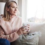woman enjoys coffee at home after facelift