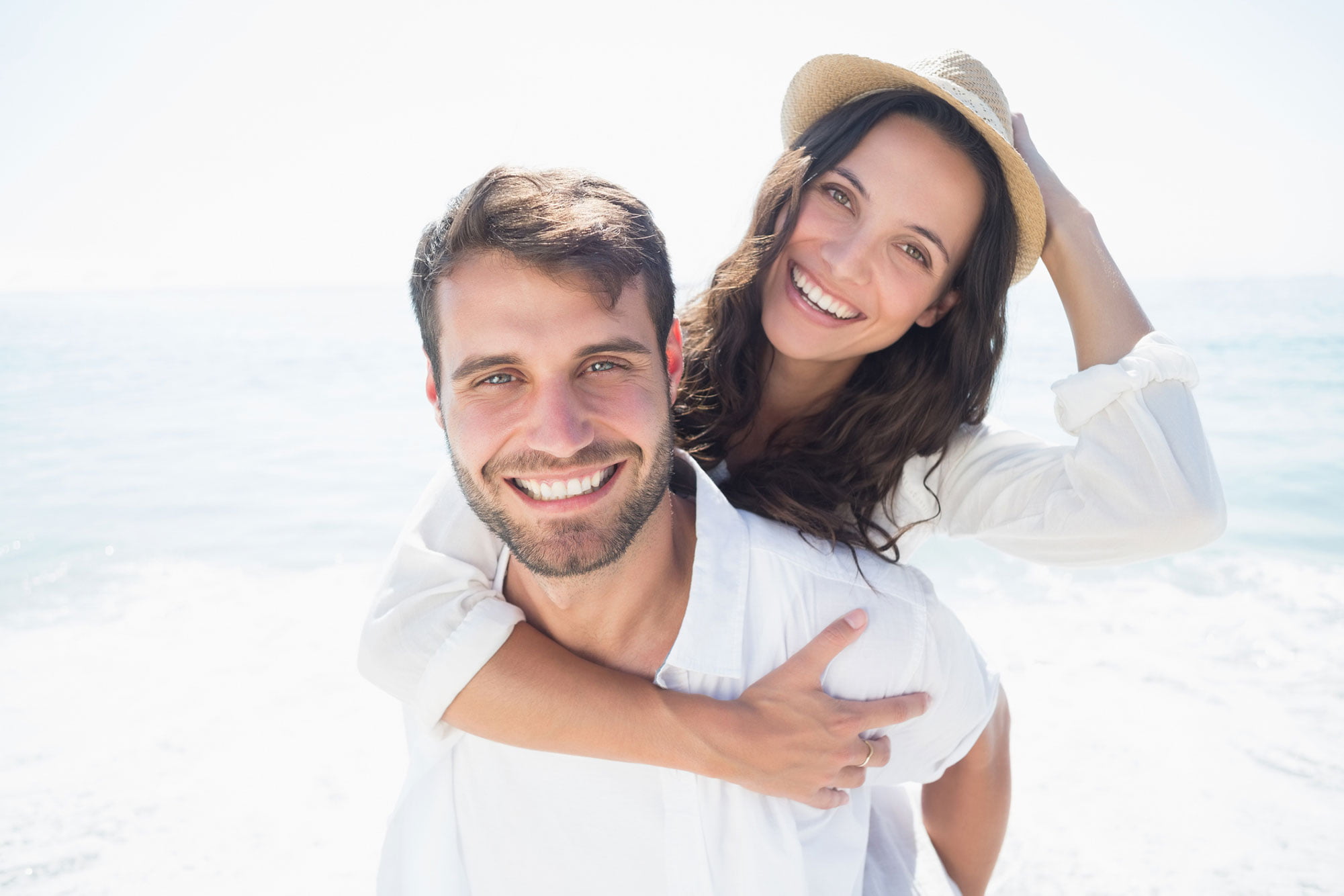 Happy man and woman couple on the beach
