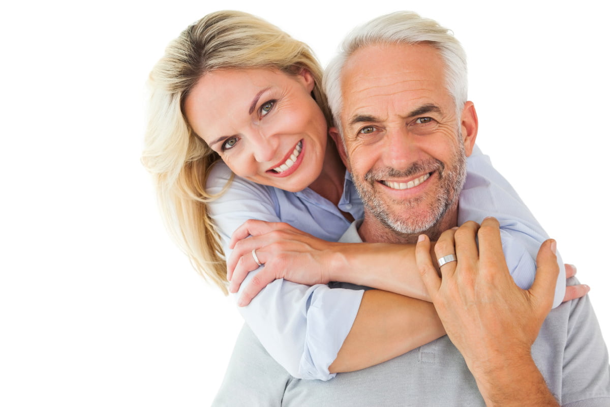 Senior man and woman smiling and embracing