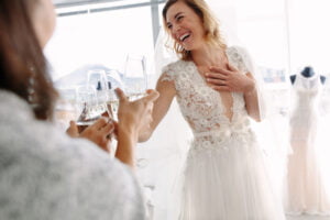 Woman Toasting Bridal Party While Trying on Wedding Dresses in Philadelphia