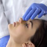 Woman Getting Splint Placed by Plastic Surgeon for Rhinoplasty Recovery