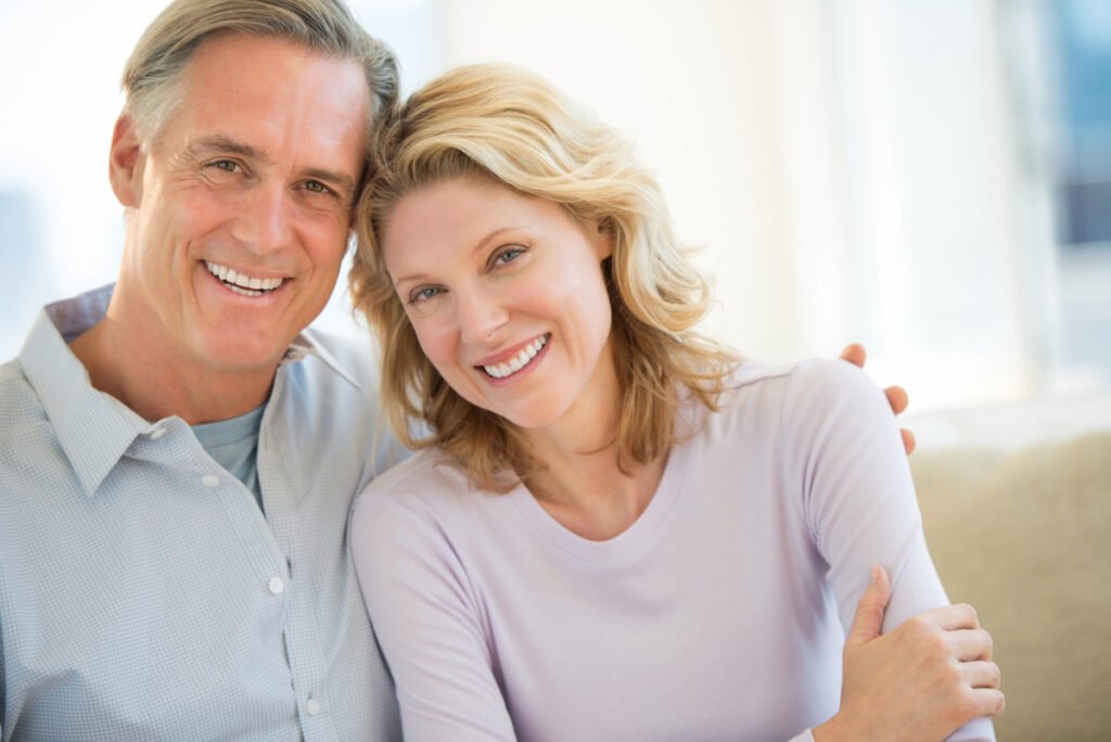 Happy senior couple smiling following deep plane facelift