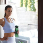 Healthy Philadelphia woman posing with green drink during a day of wellness at local Main Line businesses