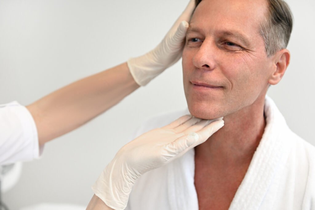 Man at facelift consultation with double board certified plastic surgeon