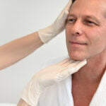 Man at facelift consultation with double board certified plastic surgeon