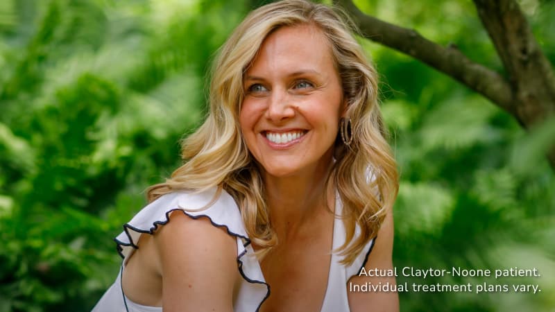 Woman smiling outdoors with smooth, firm skin