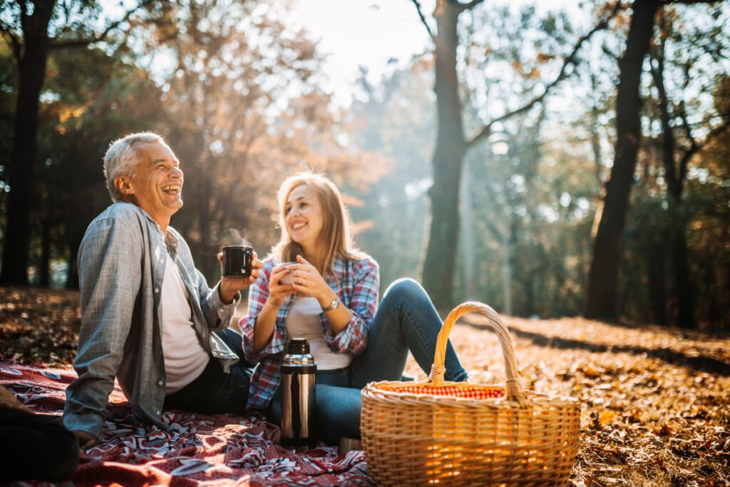 Father and daughter smiling having a picnic during autumn in the Main Line area of Philadelphia