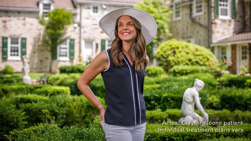 model wearing white navy blue shirt and white hat 