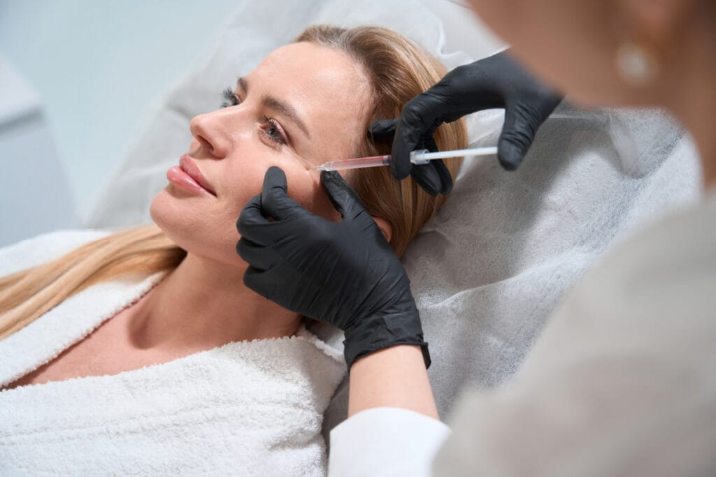 Woman getting cheek filler for anti-aging facial rejuvenation