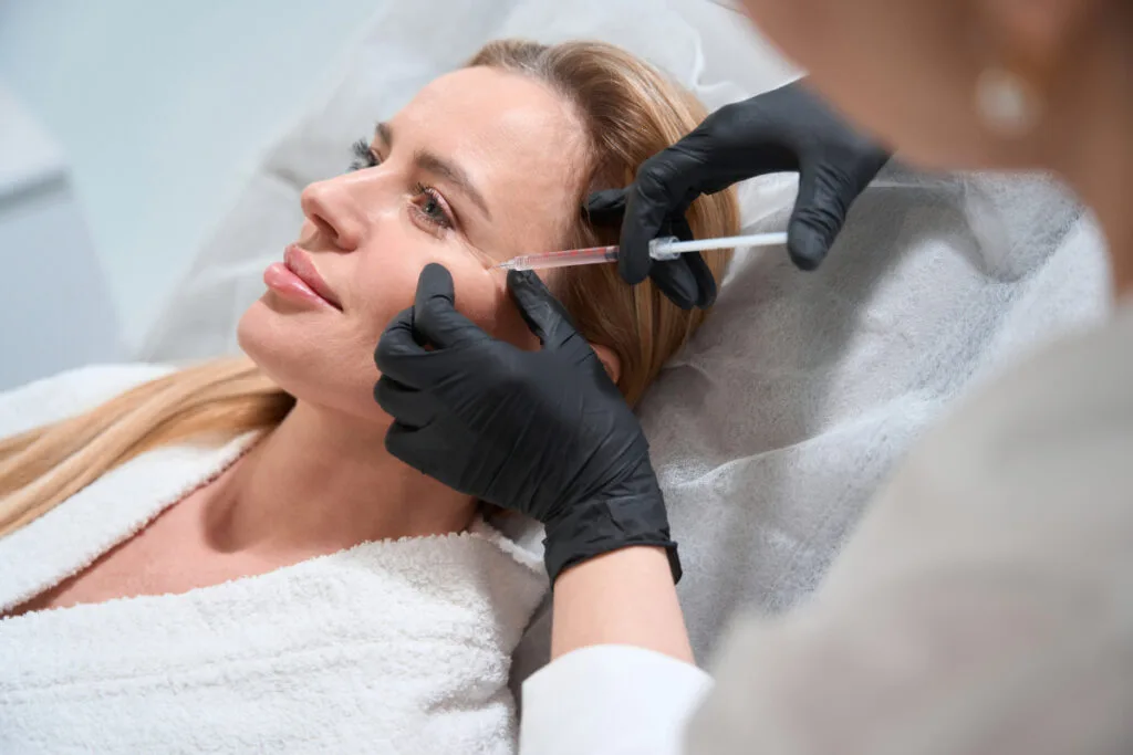 Woman getting cheek filler for anti-aging facial rejuvenation