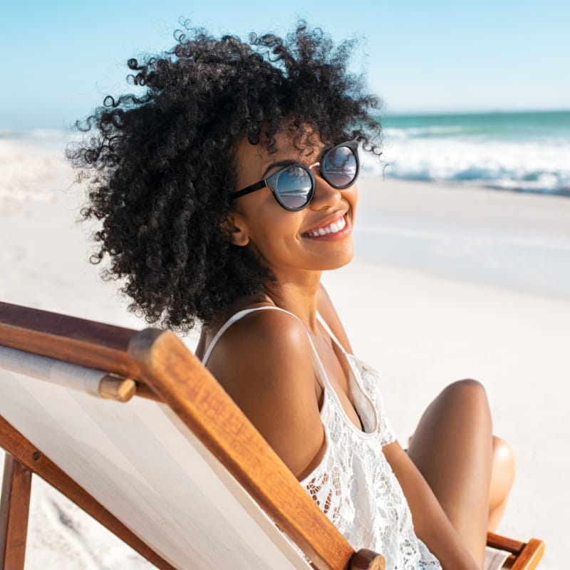 Woman lounging in a chair by the beach