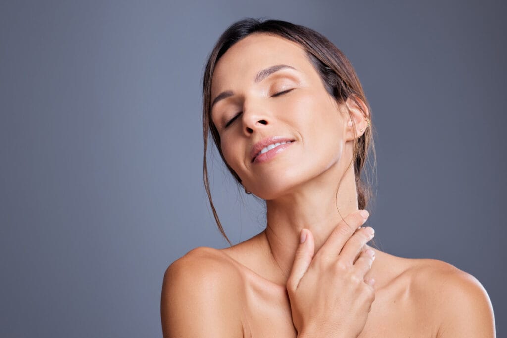 Mature woman touching neck