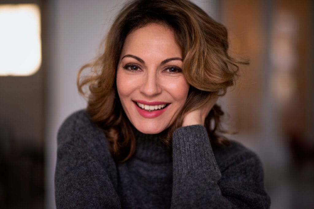 Woman wearing sweater smiling