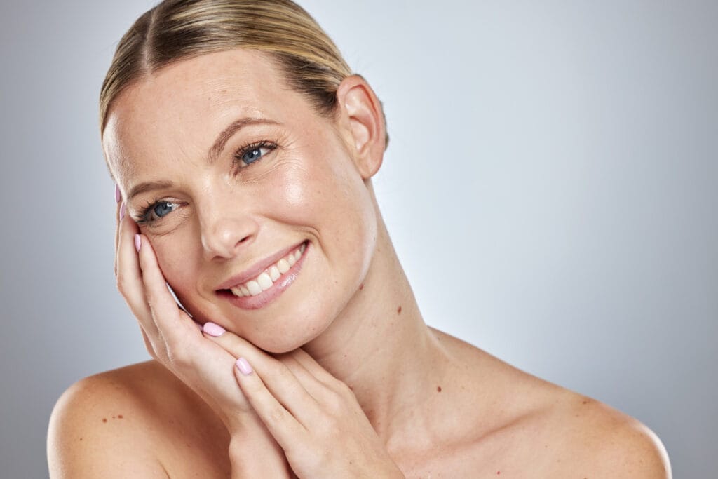 Early 40s woman with healthy, glowing skin after skin-tightening treatments at a medical spa